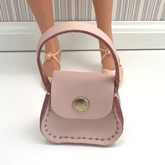 The handmade blush pink real leather mini handbag is perfect for 1/4 scale fashion dolls or an oversized handbag for a 1/6 scale fashion doll. It would also make a great purse decoration, keychain, earbud storage, or addition to your miniature collection. It is a wonderful gift for any doll collector, mini collector, fashion designer, content creator, or older child.  WARNING: CHOKING HAZARD-SMALL PARTS NOT SUITABLE FOR CHILDREN UNDER 3 YEARS OLD.  Includes 1 handbag. Dolls, clothing, shoes, and any props are not included. Materials: Leather, Waxed Thread, Double Head Rivets, Magnets, and 1 Snap Rivet. Designed and constructed by myself.  Ships from 94505, Discovery Bay, Northern California, USA. Small Pink Shoulder Bag, Purse Decorations, Discovery Bay, Miniature Collection, Mini Handbag, Mini Handbags, Collector Dolls, Doll Clothing, Pink Leather