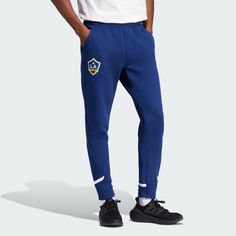 adidas Shop the LA Galaxy Designed for Gameday Travel Pants - Blue at adidas.com/us! See all the styles and colors of LA Galaxy Designed for Gameday Travel Pants - Blue at the official adidas online shop. Blue Sporty Sweatpants With Three Stripes Branding, Sporty Blue Joggers With Three Stripes Branding, Sporty Blue Sweatpants With Three Stripes Branding, Casual Sports Bottoms With Three Stripes, Casual Three Stripes Bottoms For Sports Events, Adidas Three Stripes Bottoms For Sports Events, Blue Adidas Activewear For Jogging, Blue Sports Joggers With Three Stripes Branding, Blue Sports Joggers With Three Stripes