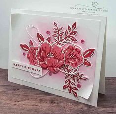 a handmade card with flowers on the front and bottom, says happy birthday in red