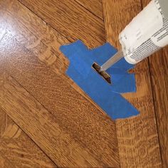 a piece of blue paper is cut out to look like an airplane on the floor