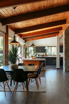 a dining room table with chairs and a potted plant