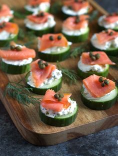 cucumbers with smoked salmon and capers on them are ready to be served