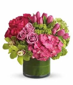 a vase filled with pink and green flowers