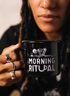 a close up of a person holding a coffee cup with the words morning ritual on it