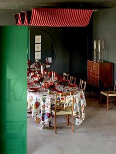 a dining room with green walls and red curtains