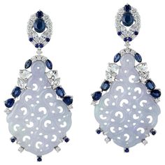 These stunning hand carved Jade earrings are crafted in 18-karat gold. It is set in 23.05 carats Jade, 4.96 carats blue sapphire and .90 carats of sparkling diamonds. FOLLOW MEGHNA JEWELS storefront to view the latest collection & exclusive pieces. Meghna Jewels is proudly rated as a Top Seller on 1stdibs with 5 star customer reviews. All items manufactured by us are handmade and can be customized or redesigned. Composition Size-54X24 MM Total Weight-14.84 Gold Weight(Gms)-9.058 Diamond Wt(C Jadeite Jewelry, Carved Jade, Jade Earrings, Gold Diamond Earrings, Jade Carving, Jade Jewelry, Jewelry Brand, Women Diamond, Earring Jewelry