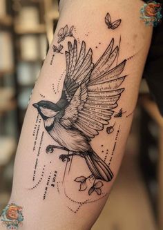 a black and white bird tattoo on the right arm, with butterflies flying around it