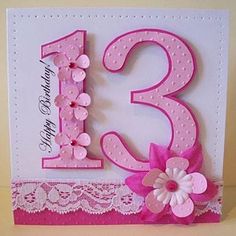 a pink and white birthday card with flowers on the number 13, decorated with lace