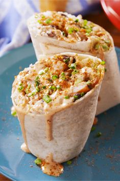 two burritos on a plate with the text old bay shrimp burritos