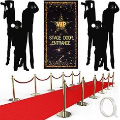 the stage door entrance is decorated with red carpet and rope barriers for people to walk on