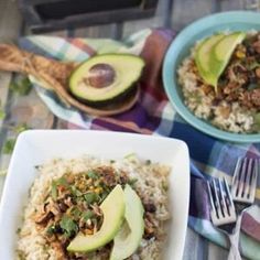 three bowls of food on a table with utensils