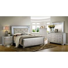 a bedroom with a bed, dressers and mirror in it's center area