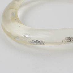 This is part of Chairish’s Costume Jewelry assortment.  An elegant Italian artisan designer studio collar choker necklace.  Lucite or resin rigid bib shape in translucent clear color ornate with silver flakes inclusions in an organic abstract free-form design. Silvered metal chain to adjust the length. No visible maker's mark. Measurements: The inner circumference is 16.57 in (42 cm) - the front height is 1 in (2.6 cm) - the opening is 3.38 in (8.5 cm) - the necklace will fit an average 14.57 in Elegant Clear Resin Jewelry, Organic Abstract, Collar Choker, Designer Studio, Transparent Resin, Form Design, Choker Collar, Maker's Mark, Collar Necklace