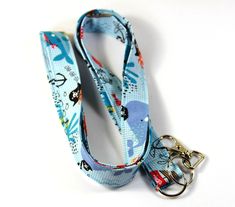 This cute lanyard has beautiful sea life with pirates fishes and whales. It is perfect for any occasion. You can leave me a convoy if you need a different size. You can have a wardrobe of lanyard to match your outfit. This lanyard is made of soft 100% cotton fabric to give a comfortable feel around your neck. This lanyard is easy to take care. You can spot clean and throw in a washer and hang dry. If you want you can iron and it is ready to use. These lanyards are perfect if you have metal aller Blue Lanyard With Key Leash For Gift, Blue Lanyard With Key Leash As Gift, Blue Lanyards With Key Leash As Gift, Sea Fabric, Whale Fish, Cute Lanyard, Cute Lanyards, Patriotic Fabric, Fabric Lanyard