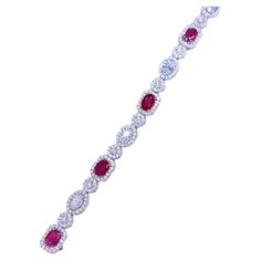 An exquisite bracelet, so chic and refined design, ideal for glamour ladies, because style is very sophisticated, unique , by Italian designer. Bracelet come in 18k gold with 6 pieces of Natural Unheated Mozambique Rubies , in perfect oval cut , spectacular color , extra fine quality, of 4,55 carats, and 323 pieces of natural diamonds of 6,08 carats, G/F color VS clarity, very sparkly and bright. Piece of high jewelry. Handcrafted by artisan goldsmith. Excellent manufacture and quality. Complete with AIG report. Note: on my shipment, no taxes. Diamonds Bracelet, Diamond Pendants Designs, Designer Bracelet, Ruby Bracelet, Modern Bracelets, Italian Designer, Pendant Design, High Jewelry, Mozambique