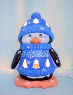 a penguin wearing a blue hat and scarf