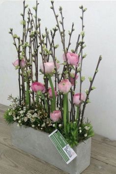 pink flowers in a planter on a wooden table with an instagramr for pinter