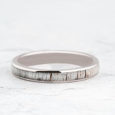 a wedding ring with white marble in the middle