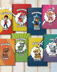 the paw patrol character notebooks are lined up in different colors and sizes, with cartoon characters on them