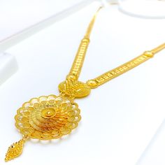 Radiate elegance with this floral-inspired necklace set in radiant 22k yellow gold, weighing 52.0 grams. The necklace, with a length of 25" and a captivating 3.25" drop, showcases intricate detailing. Adjust the fit using 0.6" adjustable links and secure it with a hook lock. Complete the ensemble with matching 1.1" earrings featuring convenient screw-back posts. PRODUCT DETAILS Gold Purity(karat): 22k Gold Weight(grams): 52.0 Item Finish: Yellow Gold Set Length: 25" Drop Length: 3.25" Adjustable 22k Gold Filigree Necklaces, 22k Gold Filigree Yellow Necklaces, Yellow Gold-plated Filigree Necklace, 22k Yellow Gold Bridal Necklace With Filigree, 22k Yellow Gold Filigree Bridal Necklace, Inspired Necklace, Yellow Gold Setting, A Hook, Gold Set