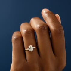 a woman's hand with a diamond ring on it