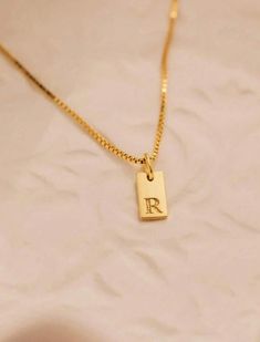 Beautiful, elegant and totally adorable! The Mini Initial Tag Necklace is just what your jewelry collection needs. A contemporary update to the classic monogram necklace, personalize it with your initial or add additional charms to the sparkling box chain to highlight multiple initials. The small, simple design makes this necklace fun and attractive and perfect for everyday wear. Elegant Engraved Charm Necklaces With Rectangular Pendant, Elegant Engraved Charm Necklace With Rectangular Pendant, Elegant Sterling Silver Nameplate Initial Necklace, Elegant Engraved Nameplate Initial Necklace, Initial Pendant Charm Necklace Gift With Box Chain, Gift Initial Pendant Charm Necklace With Box Chain, Elegant Name Necklace With Rectangular Pendant, Elegant Rectangular Pendant Name Necklace As Gift, Elegant Rectangular Pendant Name Necklace For Gift