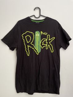 a t - shirt with the word pickle on it hanging from a hanger