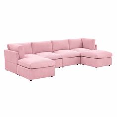 a pink sectional couch sitting on top of a white floor