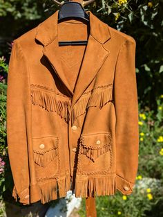 1950's custom-made, fringe, buckskin Leather women's (small) Western wear jacket. Unlined, except the cuffs. Marked "34" in pencil on the interior back neckline.  Measurements in photo.  Great, wearable condition with some minor surface dirt. Needs to be cleaned.  Buyer responsible for cleaning. Vintage Fitted Outerwear With Fringe, Vintage Leather Outerwear For Rodeo, Fitted Vintage Outerwear With Fringe, Vintage Leather Jacket With Fringe For Winter, Vintage Fringe Leather Jacket For Winter, Vintage Winter Leather Jacket With Fringe, Vintage Brown Leather Jacket For Rodeo, Vintage Fall Outerwear For Western-themed Events, Vintage Brown Fringed Outerwear