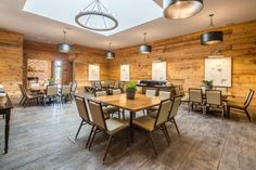 a large dining room with wooden walls and tables set up for an event or function