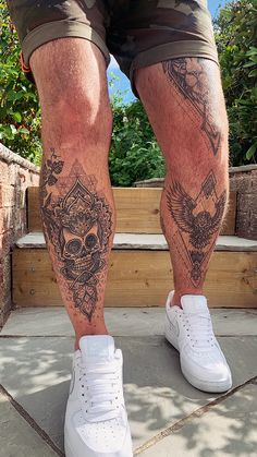 a man's legs with tattoos on them