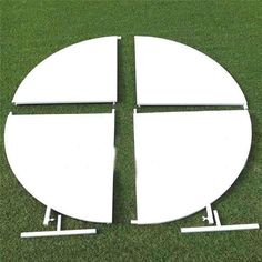 a white circular object sitting on top of a green field