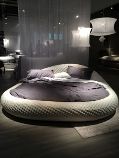 a round bed in the middle of a room