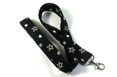 This cute lanyard has stars on black. It is perfect for any occasion. You can leave me a convoy if you need a different size. You can have a wardrobe of lanyard to match your outfit. This lanyard is made of soft 100% cotton fabric to give a comfortable feel around your neck. This lanyard is easy to take care. You can spot clean and throw in a washer and hang dry. If you want you can iron and it is ready to use. These lanyards are perfect if you have metal allergy. Each of these lanyards will hav Black Lanyard With Key Leash As Gift, Adjustable Black Badge Holder With Key Leash, Adjustable Black Lanyards For School, Adjustable Black Lanyard For School, Cute Lanyard, Stars Fabric, Cute Lanyards, Black Lanyard, Star Badge