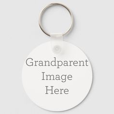 a white round keychain with the words grandparent photo here on it's side