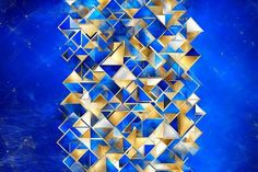 an abstract painting with gold and blue shapes on a dark blue background that looks like it is floating in the air