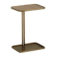 a gold side table with a tray on it