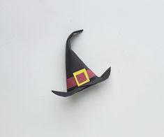 an origami witch's hat on a white surface