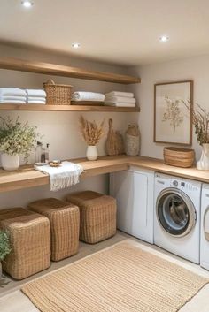 a washer and dryer in a room with wooden shelves on the wall next to each other