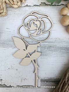 a wooden cutout of a rose with leaves