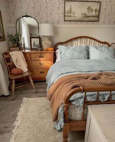 a bedroom with a bed, dresser and mirror