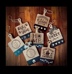 some tags are hanging on a wooden surface with string and paper decorations around them that read, farmhouse kitchen home sweet produce