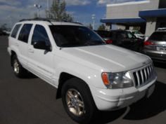 a white jeep parked in a parking lot