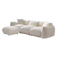 a large white couch with pillows on it's back and side ends, sitting in front of a white background