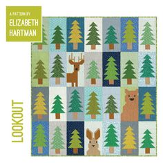 a quilt pattern with trees and deers on the front, which is also in green