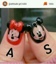 two fingers with mickey and minnie mouse faces painted on them, one has a red bow