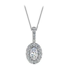 This delicate pendant features one oval-shaped diamond that is approximately 0.23-carat total weight ( 5mm x 3mm) encircled by a halo of perfectly matched 13 brilliant round diamonds in about 0.12-carat total weight. The pendant is measuring at 14 mm in length and 6.2 mm in width. Our clients love it! Experience the difference in person! Product details: Center Gemstone Type: NATURAL DIAMOND Center Gemstone Color: WHITE Center Gemstone Shape: OVAL Center Diamond Carat Weight: 0.23 Metal: 18K Whi Classic Oval Diamond Necklace With Halo Setting, Oval Diamond Necklace With Accents For Anniversary, Oval Diamond Necklace With Halo Setting, Timeless Oval Diamond Necklace For Anniversary, Diamond White Oval Necklace With Halo Design, Oval White Gold Diamond Necklace With Halo Setting, Oval Diamond Necklace With Halo Setting For Wedding, Oval Halo Diamond Necklace In White Gold, Oval Halo Setting White Gold Diamond Necklace