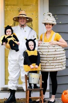 a man and woman in bee costumes with two children