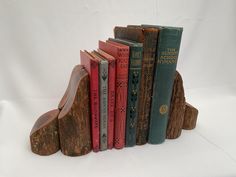 a bookend made out of wood with several books on each shelf in front of it