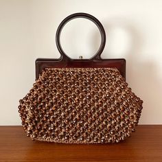 Description:  Vintage Brown Beaded Lucite Early Plastic Structured Handle Kelly Handbag Measurementsstrong>Width: 30cm, Height: 27cm, Strap to Bag: 7.5cm Brown Rectangular Embellished Bag, Beaded Brown Tote Shoulder Bag, Brown Beaded Bags For Daily Use, Brown Beaded Tote Shoulder Bag, Summer Beaded Brown Shoulder Bag, Summer Brown Beaded Shoulder Bag, Brown Beaded Handheld Bag, Handheld Brown Beaded Bag, Daily Use Brown Beaded Bags